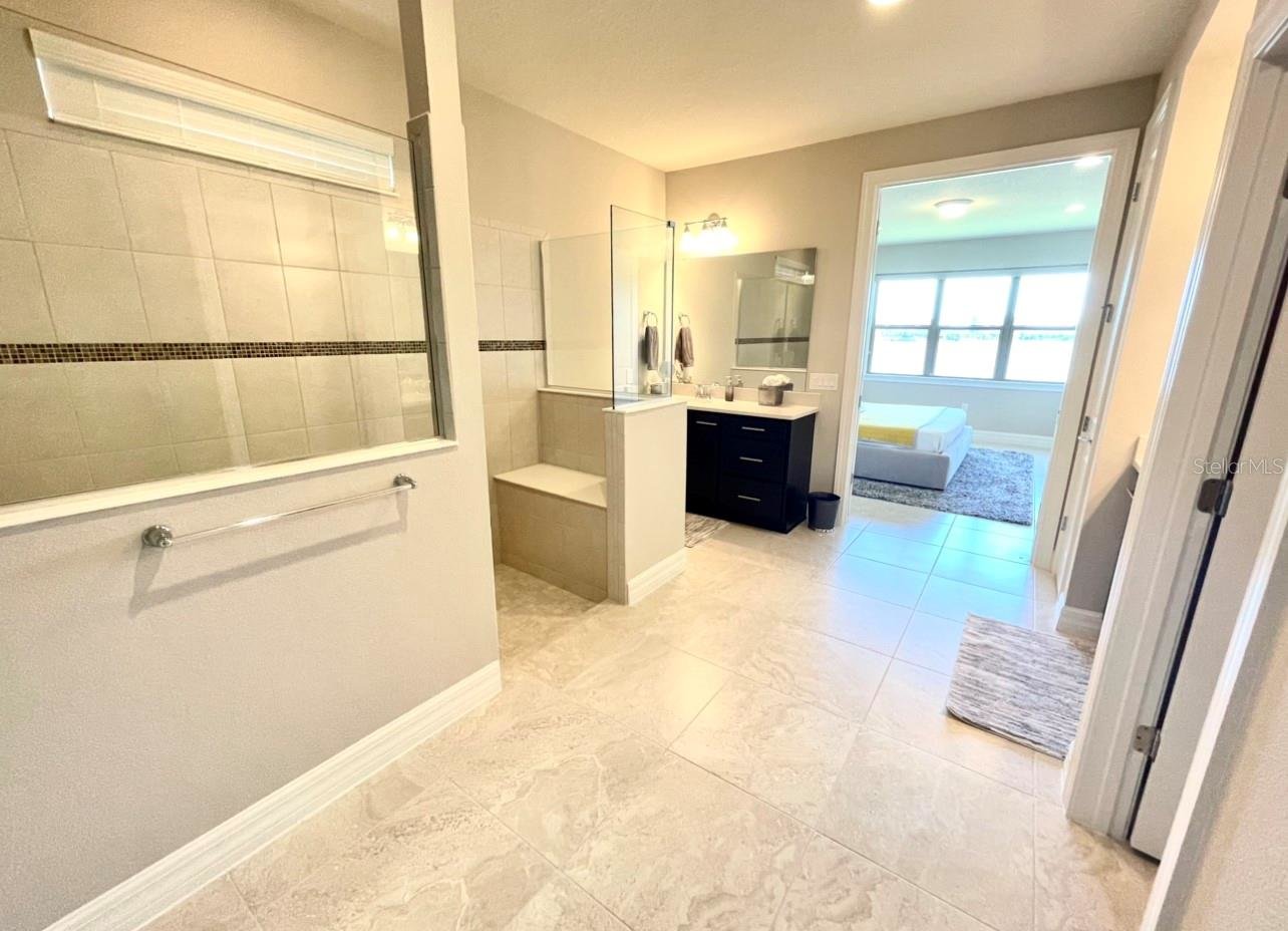 large tiled bathroom with walk in shower
